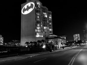 Large-scale bat signal projected on the side of a high-rise. 