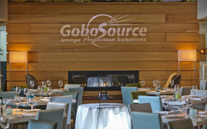 GoboSource logo projected above a restaurant fireplace