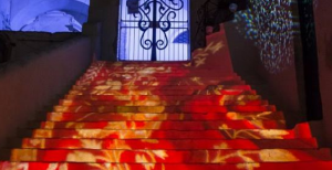 Illuminate a stairwell with a wash of red using gobo lighting. 