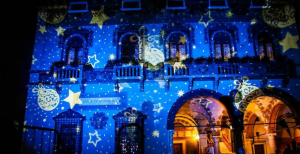 Decorate the facade of a multi-story building with a holiday scene. 