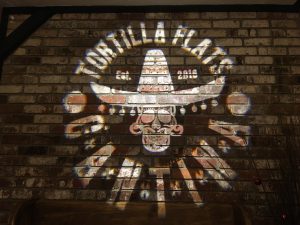 Tortilla Flats Cantina in Placerville, Ca projects a custom gobo with their logo in the entryway to promote social media sharing. 